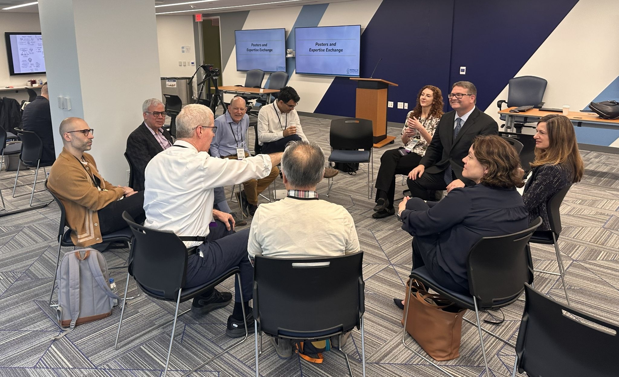 A group of people sitting in a circle and having a conversation